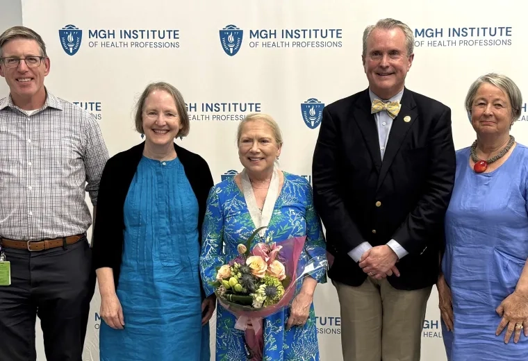 Five people standing in a row smiling