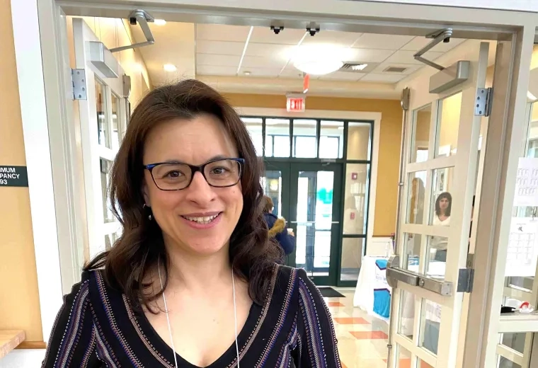 Woman holds an award she received