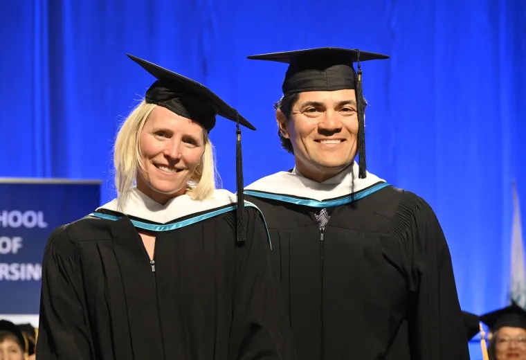man and woman in cap and gown