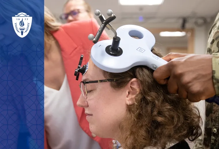 A physical therapy student practicing with advanced equipment