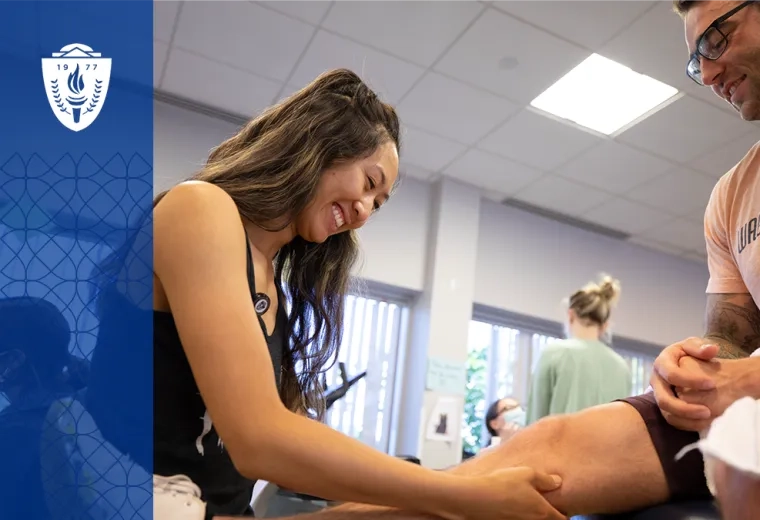 a woman lifts up the leg of a man sitting on an exam table