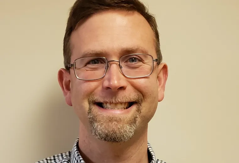 aaron has glasses and a checkered shirt