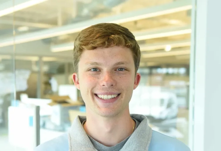 Alex Kaminsky wearing a light blue three-quarter zip up