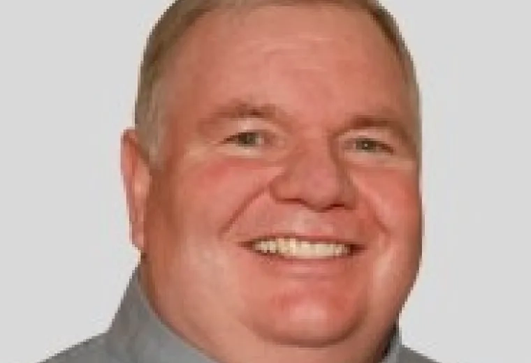 Daniel McGovern in grey collared shirt