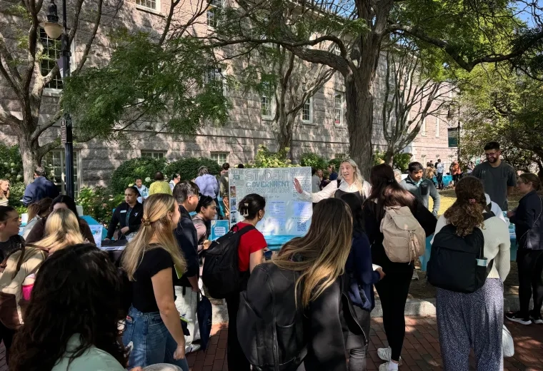Crowd of people in front of poster board