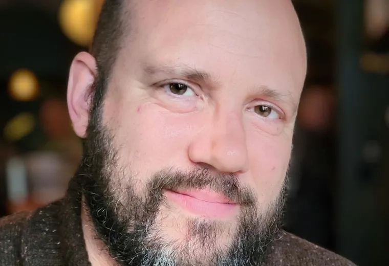 Joshua Hartshorne in brown sweater