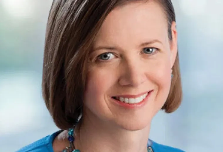 kendi wears a blue top and necklace