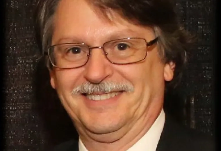 mark has a moustache and wears a suit and tie