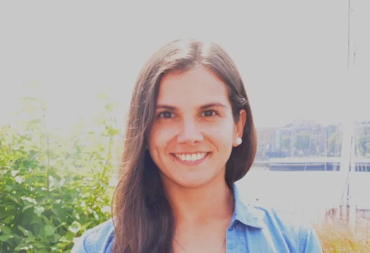 Nadine Alejandra Aranis Seguic has long brown hair and is wearing a blue denim jacket and white lace shirt