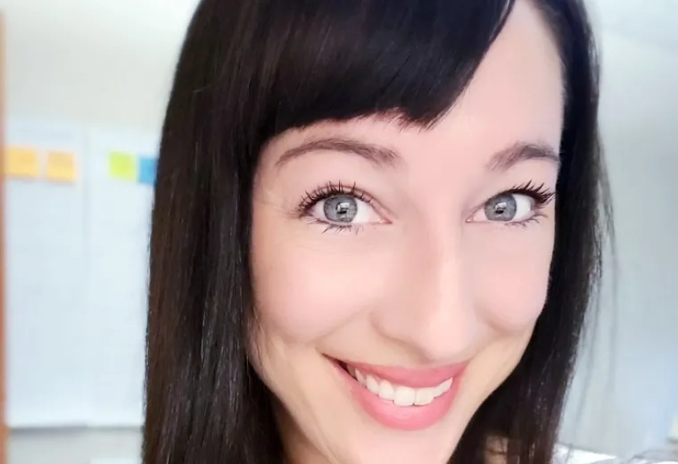 sarah has a pink and blue striped shirt and straight black hair