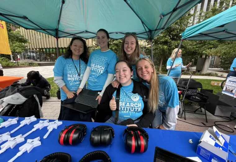 5 women at a booth with headphones on the table