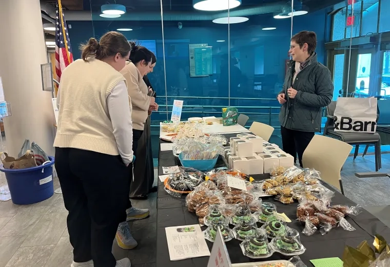 women standing at bake sale