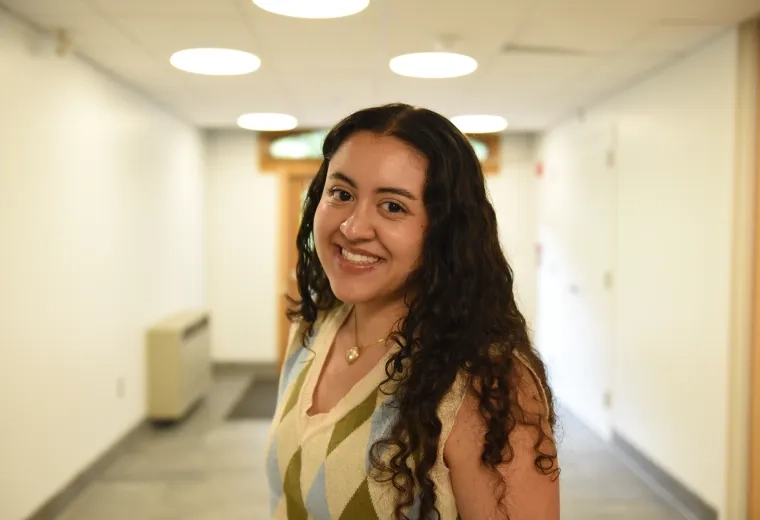 A woman stands in a hallway