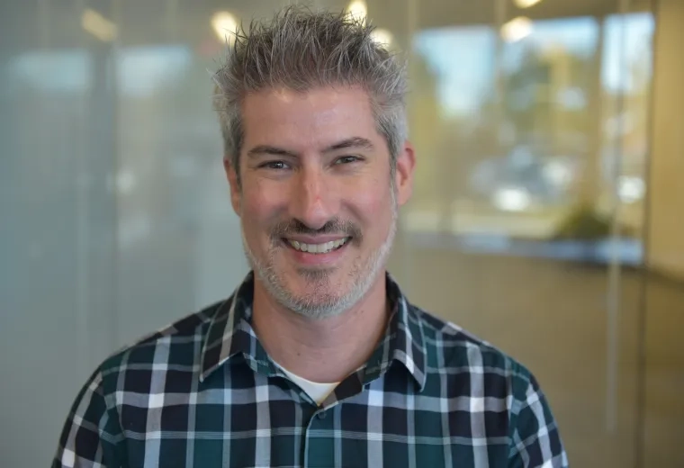 kevin has a blue plaid flannel shirt