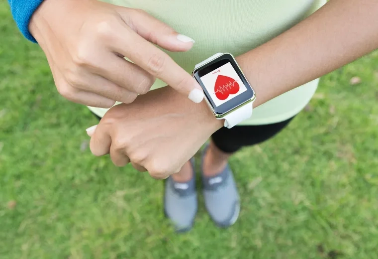 photo of a wrist with a smartwatch displaying heartrate