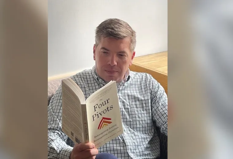 A man reads the book Four Pivots