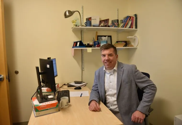 A man sits at a desk