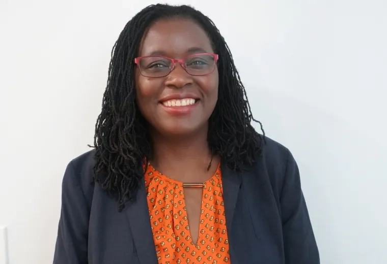 Clara has glasses and shoulder length black hair