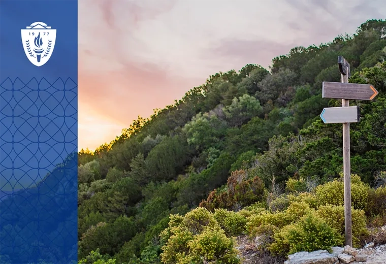 a sign post on a path in the mountains