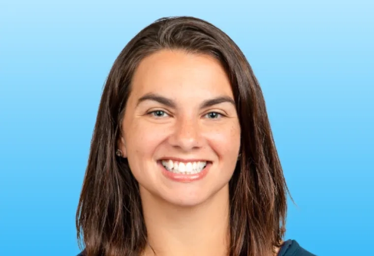 Beth Collier has straight, shoulder-length brown hair and is is wearing a dark teal shirt