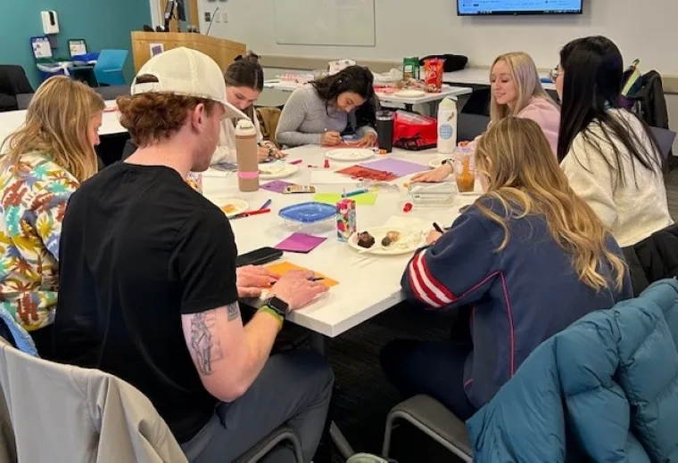 Group of adults around a table making cards