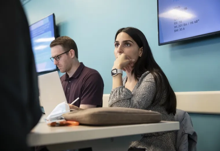 a student listens to a teacher