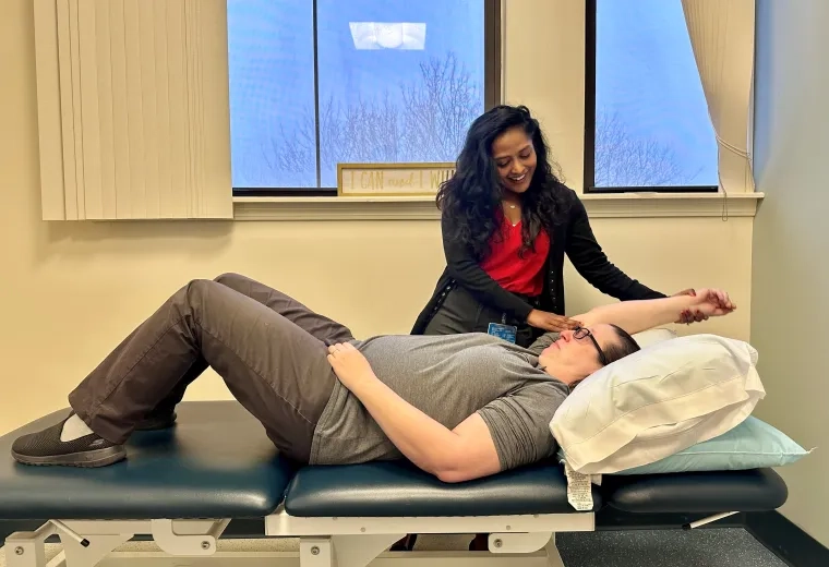 Physicla Therpist with patient on table 