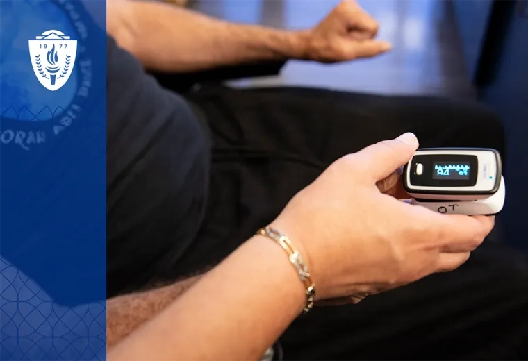 close up of hands using a digital finger device to get health stats