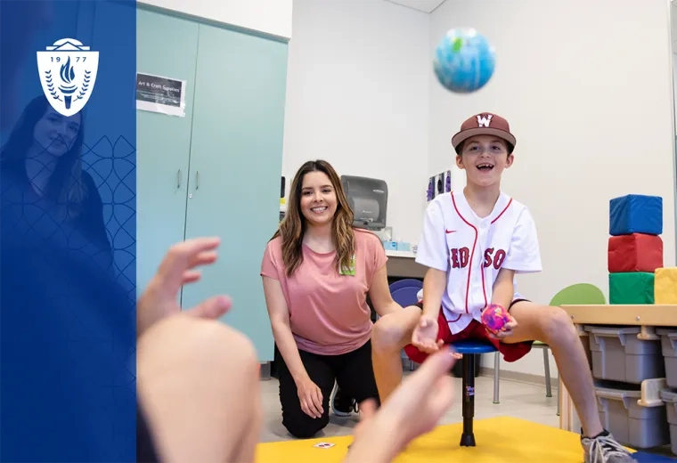 a boy throws a ball showing what occupational therapists do in a therapy setting
