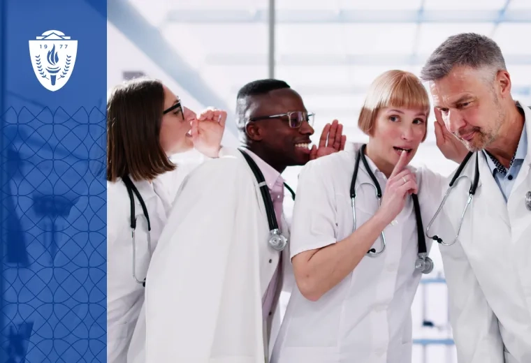 people in white lab coats whisper to each other