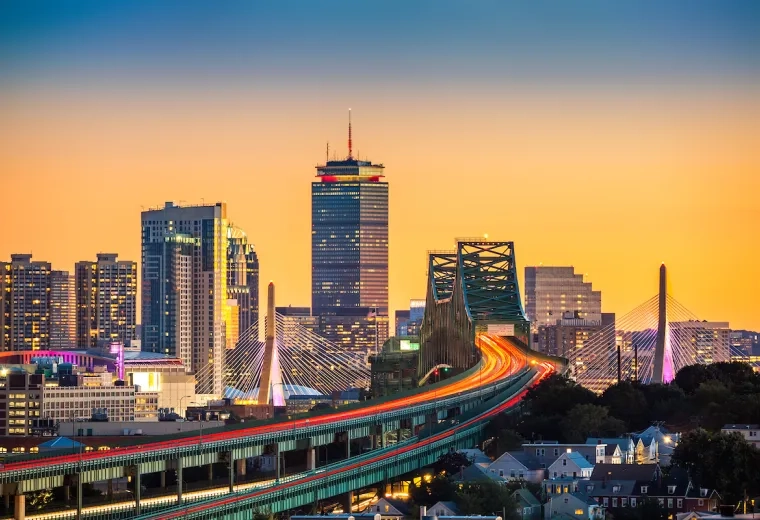 city buildings with an orange sunset sky