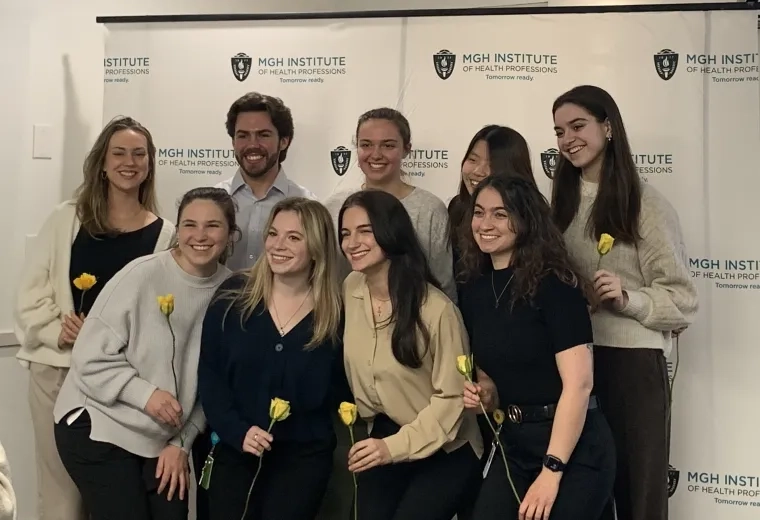 Nice people hold flowers and pose as a group