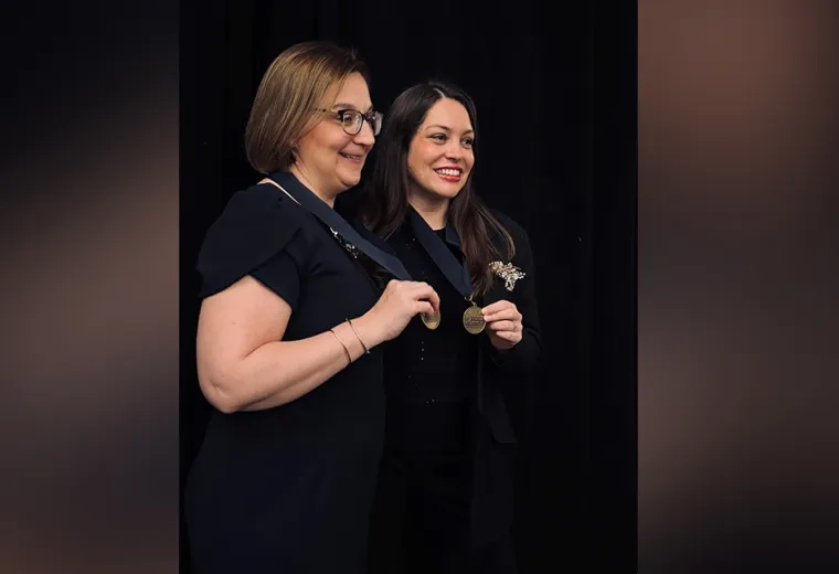 Two women holding medals 