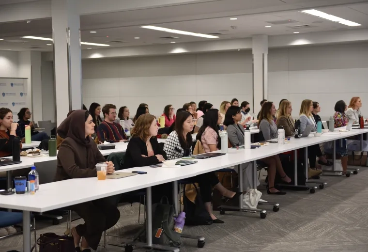 Several people sitting around a white table