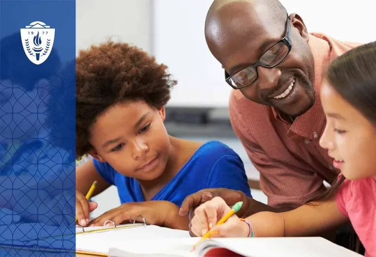 Teacher helping two students with schoolwork at a desk 