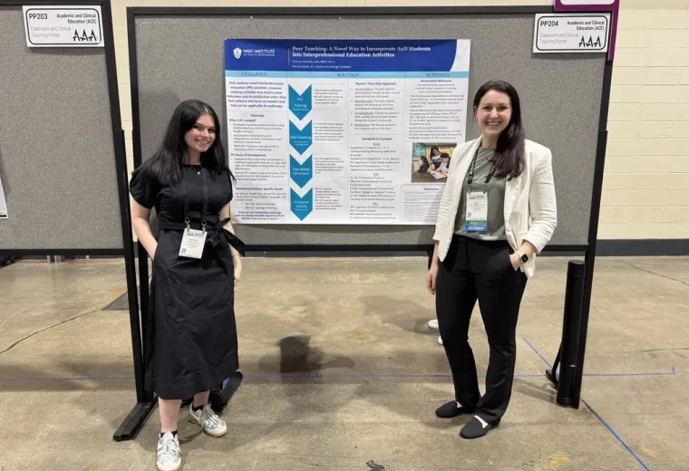 Two women in front of a poster