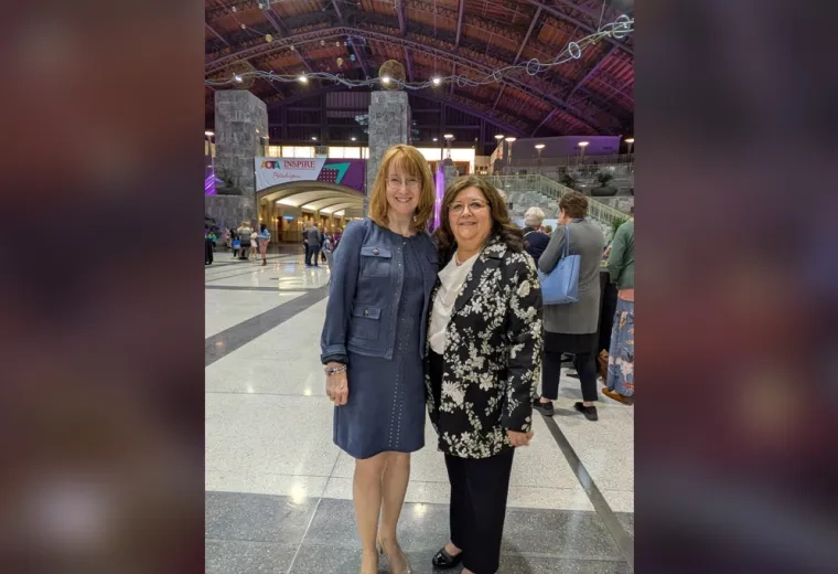 Two women pose for the camera