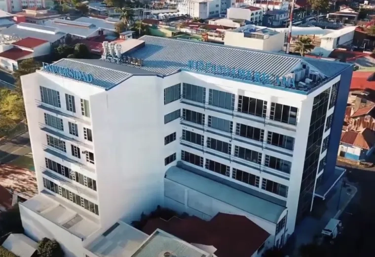 white and blue building 5 stories tall surrounded by smaller houses