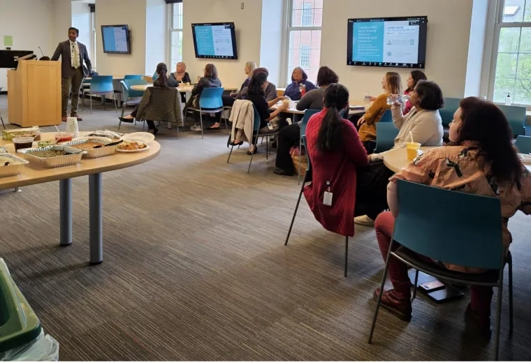 man speaking to room full of people