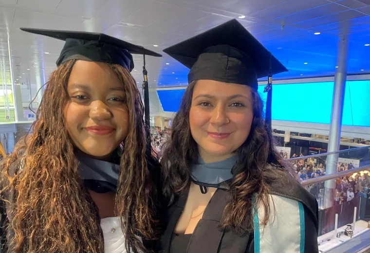 two women in cap and gown 