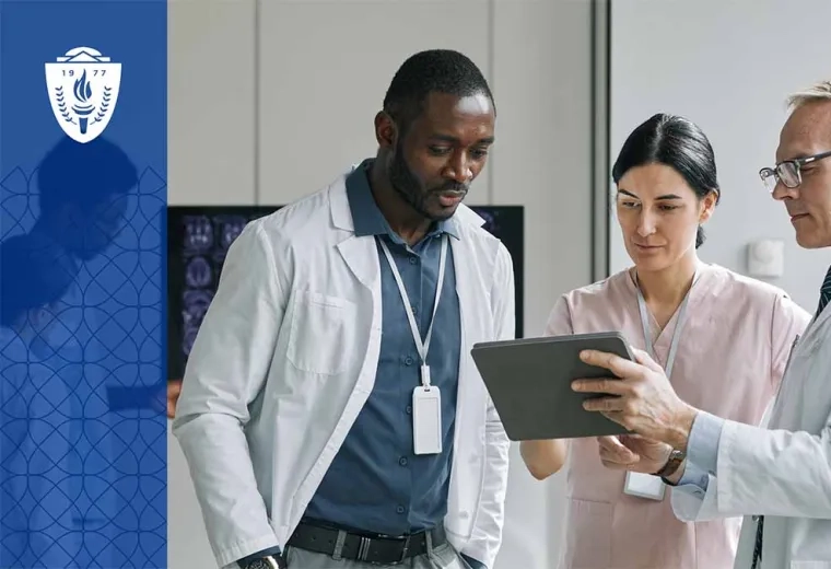 3 health care professionals looking at a tablet.