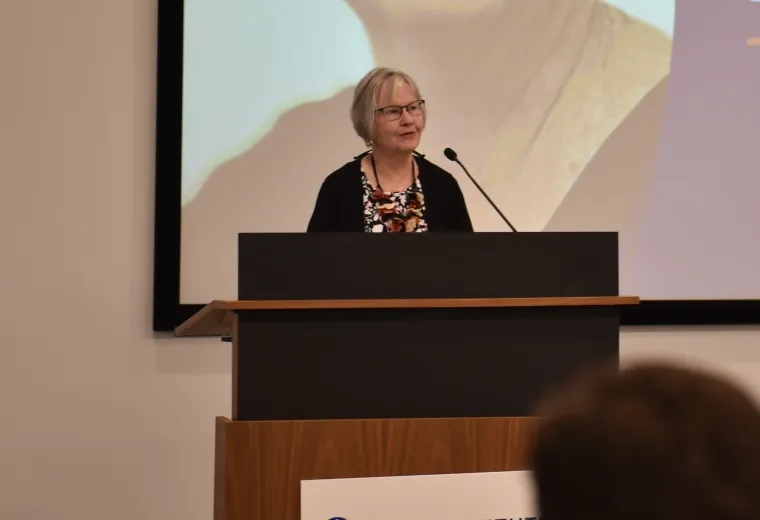A photo of a woman at a podium