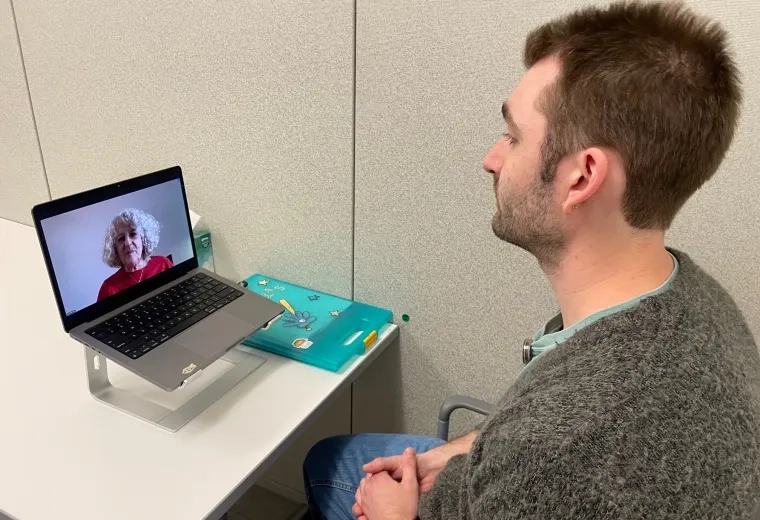 Man talking to woman via computer 