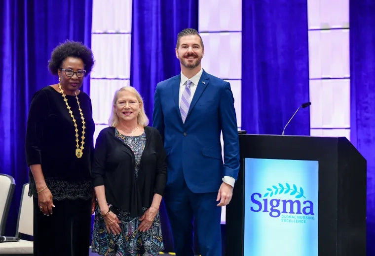 Nicholas posing with woman and man 