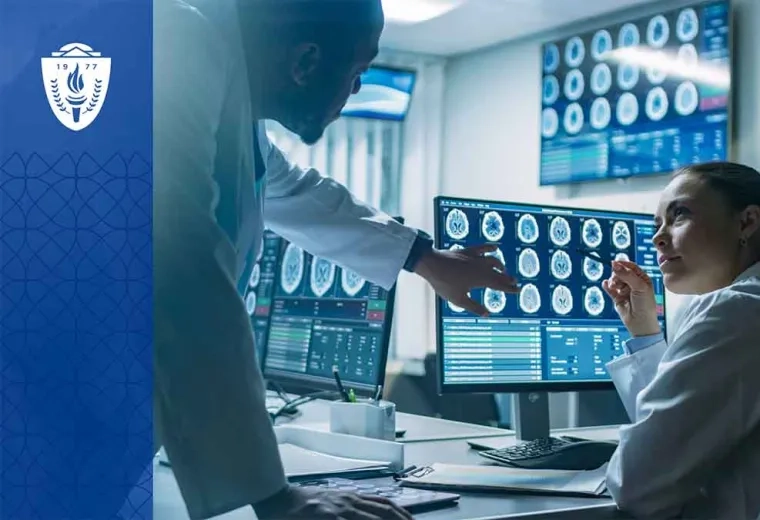 Two scientists in white lab coats looking at medical images on a computer monitor