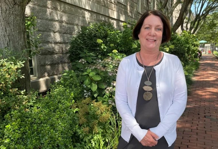 Woman standing in front of bushes 