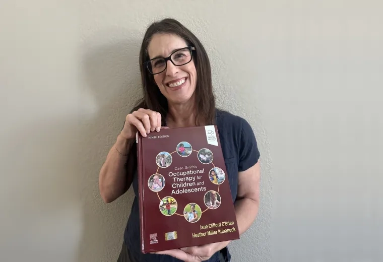 A photo of a woman holding a book