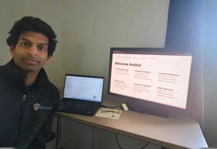 a photo of a man in front of a computer