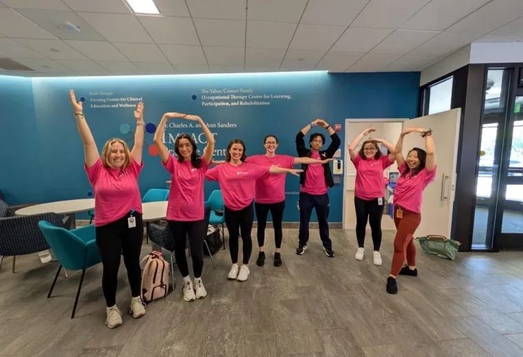 People stand in various states of movement in an open area 