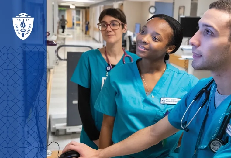 Healthcare Workers wearing scrubs and stethoscopes looking at computer screen